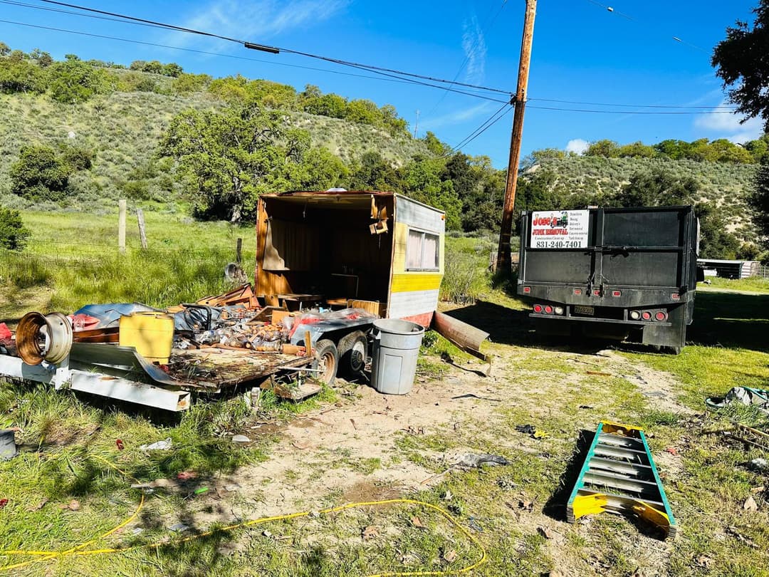 picture of a backyard full of junk that is ready to be removed