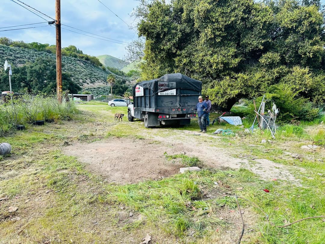 picture of truck with a dumpster full of junk